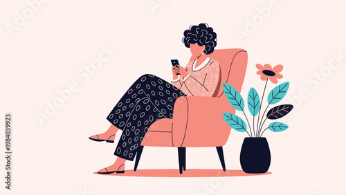 Stylish woman with curly hair relaxes in an armchair while browsing on her smartphone in a modern and minimalist home setting.