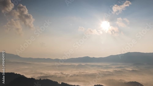 Hyperlapse by dorne Spectacular aerial view of a sea of mist covering mountain ranges under a bright mornig sun. Captures peaceful nature, morning fog, and scenic horizons at sunrise.