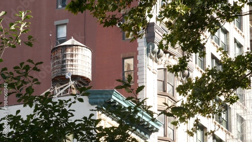 New York City urban building architecture, Manhattan rooftop, United States of America. Water tower on roof. Classic water tanks.
