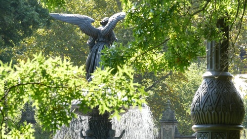 New York City Central Park Bethesda Fountain, angel statue by Bethesda Terrace on summer day, United States. Greenery and sculpture in morning. Autumn fall leaves and green trees in NYC Manhattan, USA