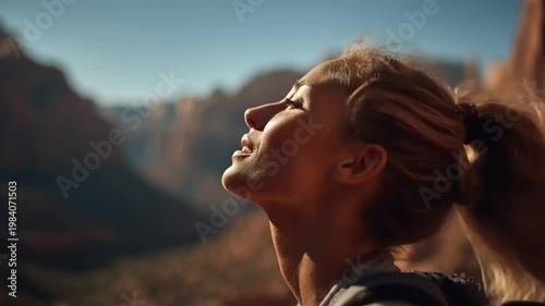 Woman gazing at canyon landscape during sunset