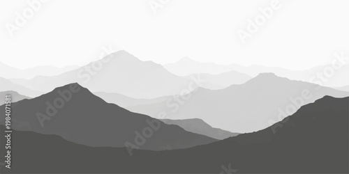 A misty morning view of a vast blue mountain range where peaks pierce through soft clouds and fog during a serene sunrise over the nature landscape