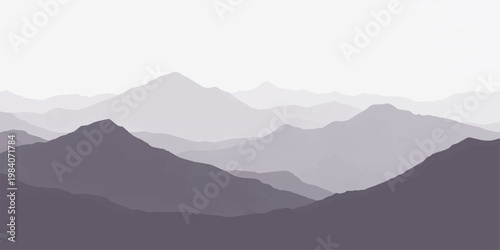 A serene morning view of misty mountain peaks and rolling hills under a blue sky at sunrise creates a majestic landscape of silhouettes within the fog-covered valley