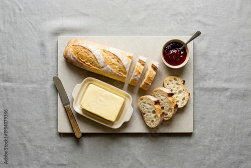 Rustic Bread with Butter and Jam on a Marble Board.