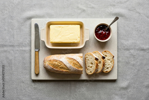 Rustic Bread with Butter and Jam on a Marble Board.