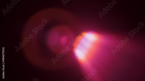 Abstract pink and orange light leak on dark background
