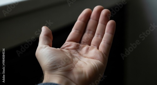 Hand gesture with palm facing forward.