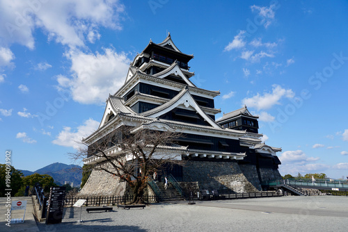 Kumamoto Castle Historic Japanese Castle With Stone Walls And Multi-Tiered Roofs Under Blue Sky