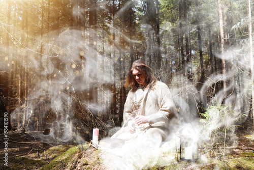 Canvastavla A man in a cassock spends a ritual in a dark forest