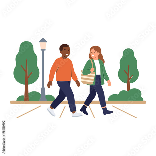 Two people walking on a sidewalk in a park