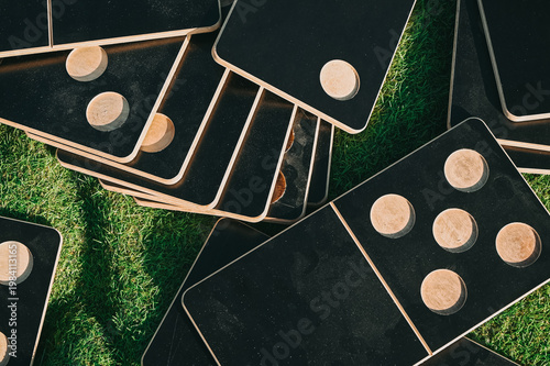 Scattered Wooden Domino Game Tiles on Grass Outdoor Scene
