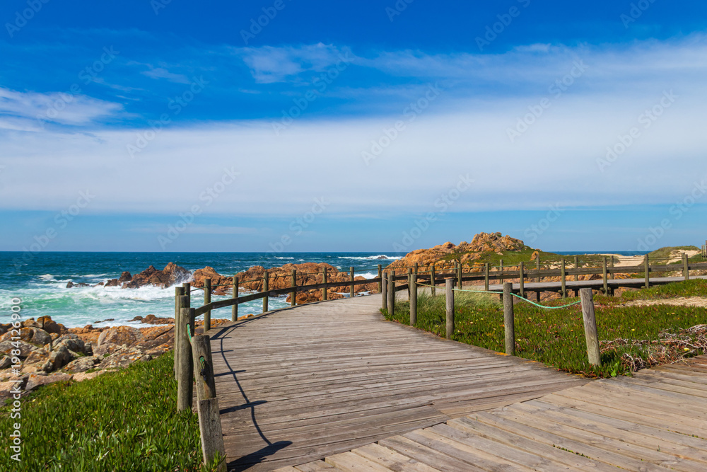 Fototapeta premium Wooden boardwalk along the Atlantic ocean coast, Portugal