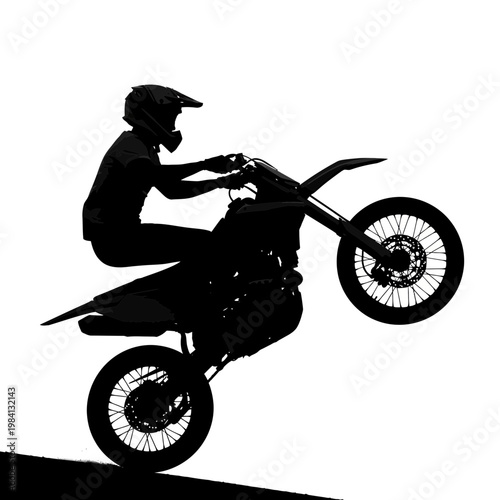 Silhouette of a Motocross Rider Performing a Wheelie on a Dirt Bike