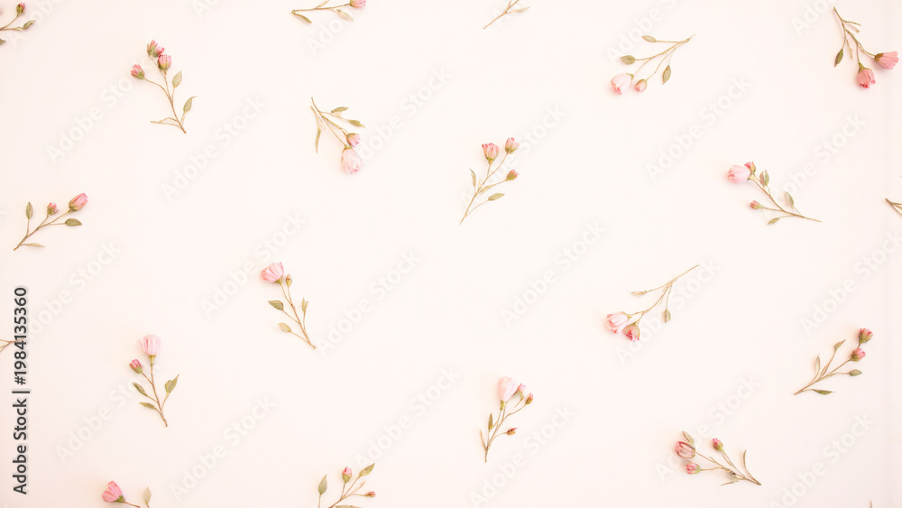 Fototapeta premium A delicate floral pattern unfolds with pink flowers and green leaves on a soft surface.