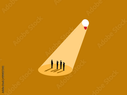 business team looked at the brightly lit light bulb