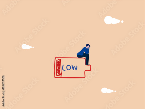 businessman sat dejectedly on a battery with low charge.