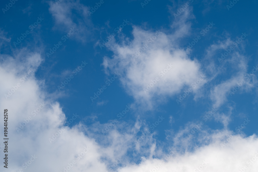 Fototapeta premium Peaceful sky with light clouds and gentle glow. Serene sky scene with scattered whitish clouds and soothing sunlight creating peaceful ambiance suitable for various designs