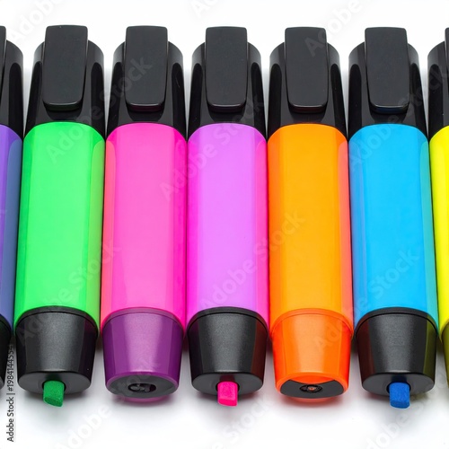 Array of vibrant fluorescent markers against a stark white background