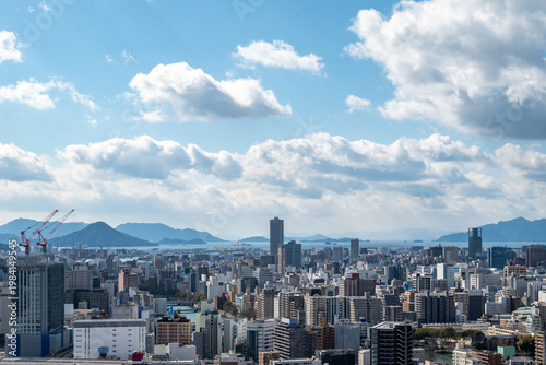 Foto Panoramic View of Hiroshima Cityscape with Skyscrapers and Seto Inland Sea under