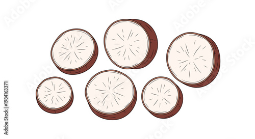 A scattered collection of sliced cassava roots, revealing their pale white interior and circular cross-section, a starchy tropical staple.