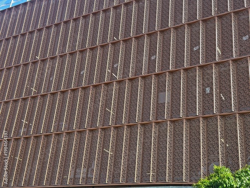 Modern car park facade with perforated metal cladding and geometric pattern
