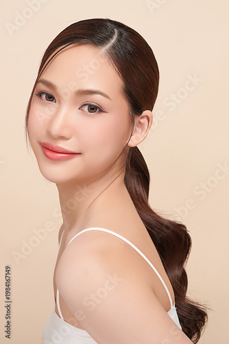 Canvastavla A beautiful young Asian woman with clean, fresh skin against a beige background