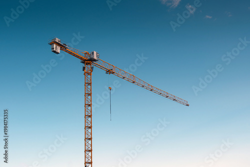 Yellow tower crane. blue sky background. 
