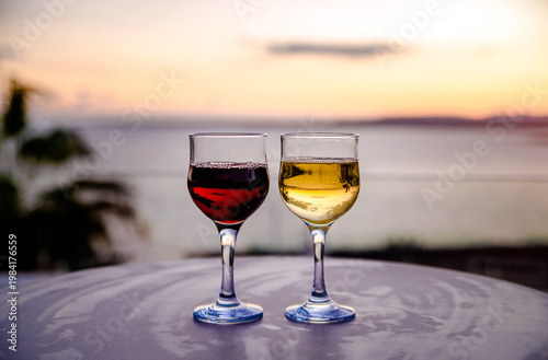 Wallpaper Mural Glasses with white and red wine on the background of a sea sunset Torontodigital.ca