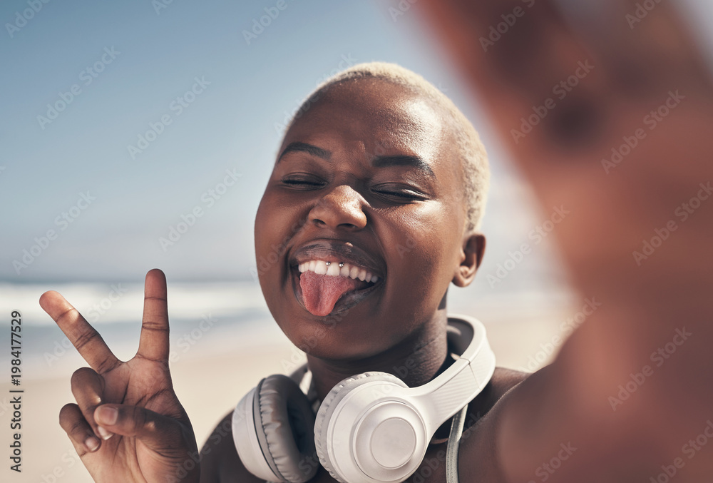 Obraz premium Fitness, selfie and black woman on beach with peace sign for workout, sport or exercise in nature. Tongue out, smile and runner with tech for social media, blog or profile picture for summer training