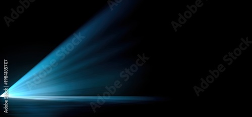 A dramatic beam of blue light cuts through the darkness, illuminating a textured surface and creating a sense of mystery and anticipation.