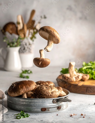 Shiitake mushrooms levitate above a pan, kitchen utensils and greens in the blurred background