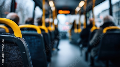 Interior view of public bus with yellow handrails and passengers
