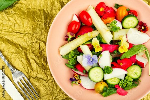 Colorful Vegetable Salad with Asparagus, Radishes and Edible Flowers on a Plate