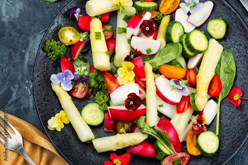 Fresh Spring Salad with White Asparagus, Radish, Cherry Tomatoes and Edible Flowers