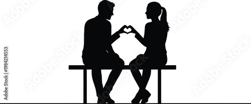 A couple sitting on a bench making a heart shape with their hands