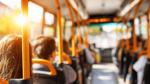 Blurred interior of public bus with passengers and sunlight