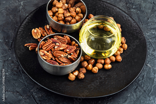 Assorted Nuts with Oil on Plate, Hazelnuts and Pecans Still Life