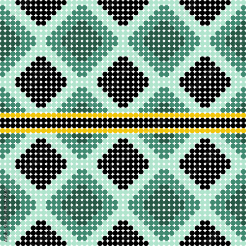 A geometric bead-style pattern with green and black diamonds and arrows on a light teal background with a central yellow and black stripe.