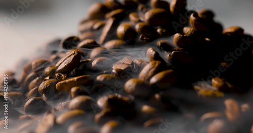 Extreme close-up of roasted coffee beans with visible steam rising, highlighting rich texture and warmth in soft, cinematic lighting. Shallow depth of field with smooth background blur