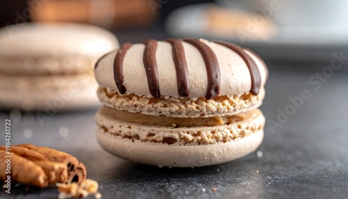 Delicious, striped caramel macaron on grey