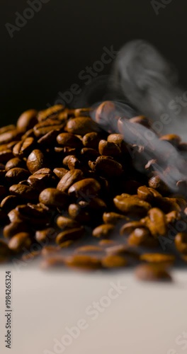 Extreme close-up of roasted coffee beans with visible steam rising, highlighting rich texture and warmth in soft, cinematic lighting. Shallow depth of field with smooth background blur