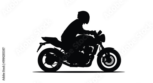 Silhouette of a motorcyclist riding a street bike in profile