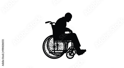 Silhouette of a man in a wheelchair facing downwards