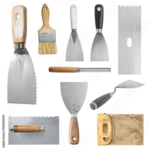 Array of varied metal/wood construction tools trowels, spatulas, scrapers, and a brush, arranged against white background