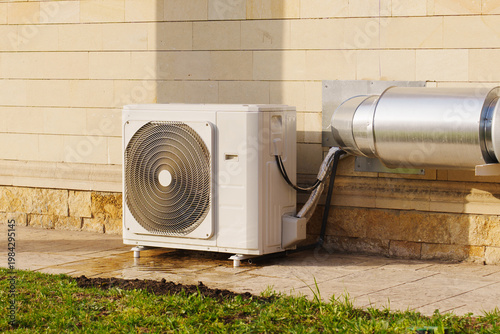 Air conditioning unit installed outside a building in sunny weather
