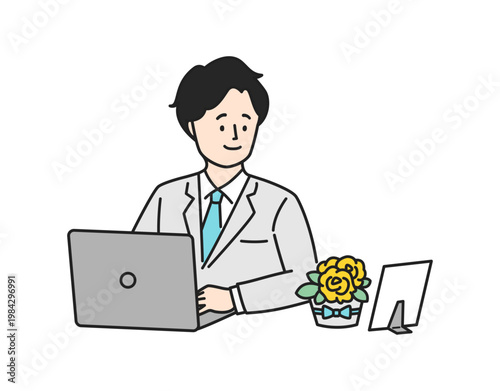 職場でプレゼントの花を眺めて微笑む会社員