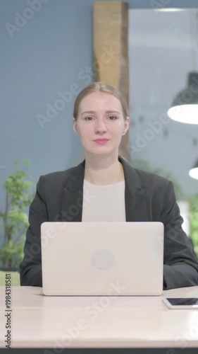 Wallpaper Mural Businesswoman Looking at Camera while using Laptop, Vertical Video Torontodigital.ca
