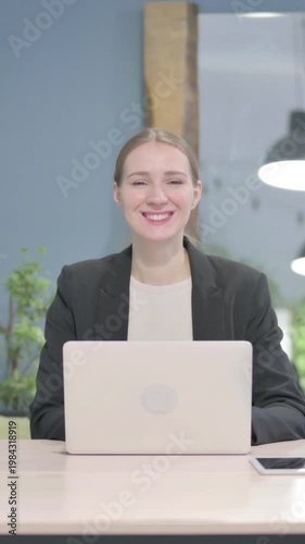 Wallpaper Mural Businesswoman Smiling at Camera while using Laptop, Vertical Video Torontodigital.ca