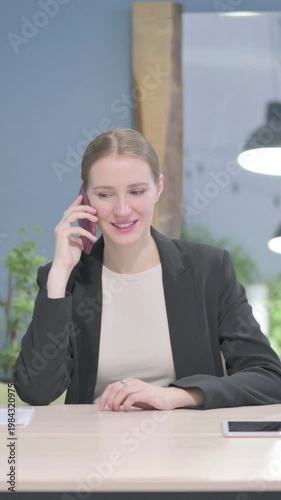 Wallpaper Mural Businesswoman Talking on Phone in Office, Vertical Video Torontodigital.ca