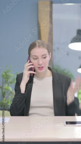 Wallpaper Mural Upset Businesswoman Talking Angrily on Smartphone, Vertical Video Torontodigital.ca